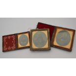 Three miniature Victorian Ambrotype photographic portraits. Two are in leather folder frames and