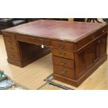 An early 20th Century oak pedestal desk, rectangular top with red leather writing surface, moulded