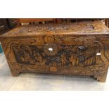 A 20th Century Oriental carved camphor blanket chest, carved detail of Japanese village. 38cm H x