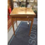An Edwardian mahogany envelope folding card table, square top with four folding envelope ends,