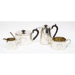 A George V matched silver four piece tea service, the shaped bodies engraved with central vacant