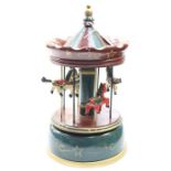 A Mid 20th Century painted musical carousel, in wood, with carved wooden horses, retaining