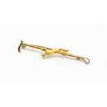 A 9ct gold hunting brooch in the form of a riding crop, depicting a fox in motion, length approx.