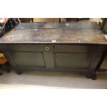 An early 18th century oak blanket chest, rectangular lid above two moulded panels on square feet.