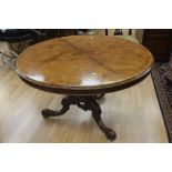 Victorian round walnut top breakfast table on tripod legs with leaf carvings on body