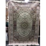 A contemporary Keshan design woollen rug, machine made, symmetrical foliage pattern on a beige