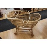 A bentwood cane moses basket on stand