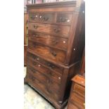 A George III mahogany chest on chest, both sections with two small drawers over three long, brass