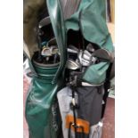 A collection of assorted golf clubs, including Dunlop and H. Bird, contained within two golf bags,
