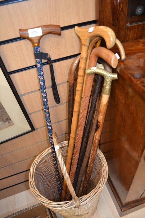 Log basket with a collection of walking sticks