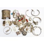 A collection of silver and white metal jewellery to include bangles, filigree brooches, chains,