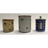 3 Poole pottery jam pots and lids, two decorated with small flower sprays, third with art deco style