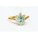 An 18ct gold ladies diamond and topaz dress ring, the central stone set with eight diamonds