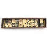 An early 20th Century dominoes set, in ebony and Bakelite