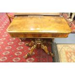 A mid Victorian rosewood fold over card table, the top swivelling round and opening, to reveal green