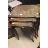 A 20th century walnut and glazed inlay nest of three tables on carved cabriole legs.