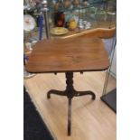 A George III mahogany tilt top tripod table, the rectangular top raised on a turned support with
