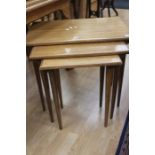 A 20th Century oak nest of tables on turned  tapered legs.