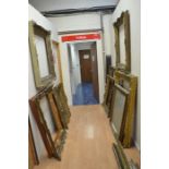 A collection of extremely large Gesso frames and mirrors in varying states of repair