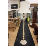 A 20th Century painted cream and gold standard lamp with  turned reed column,