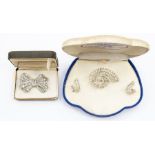 A brooch and earring set, Fifth Avenue, New York, original box, clear paste swirl design, clip