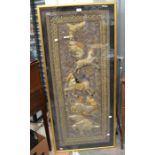 A 20th Century Burmese wall hanging, depicting animals, framed behind glass