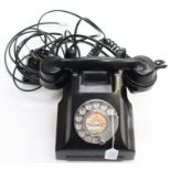 A 1960s black bakelite GPO telephone, stamped on the base with model number: 332L FNR 65/2