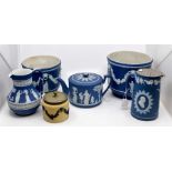 A collection of Wedgwood blue Jasper Ware, including two planters, a jug, a teapot, a hot water