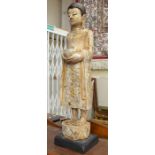 A painted wooden figure of a Thai buddha approx 72cm high