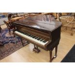 A 19th Century mahogany baby grand piano by George Steck, raised taper reeded supports on brass