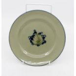 Moorcroft Leaf and Berry pattern plate in celedon green, circa 1924, signed and marked to base, 16.5