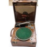 A Juno phone, circa 1920's, oak cased, wind up record player with a small collection of various 78's