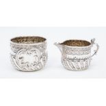 A silver sugar bowl and cream jug, embossed decoration, London 1892, maker William Hutton & Sons (