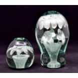 Two early 20th Century Dump paperweights, bottle green