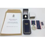 Veterans Badge in box of issue and slip along with a cased National Service Medal with spare