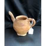 An earthenware jug. (10cm high, 12cm wide)