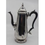 A George V silver coffee pot, plain tapering cylindrical body on spreading circular foot, with