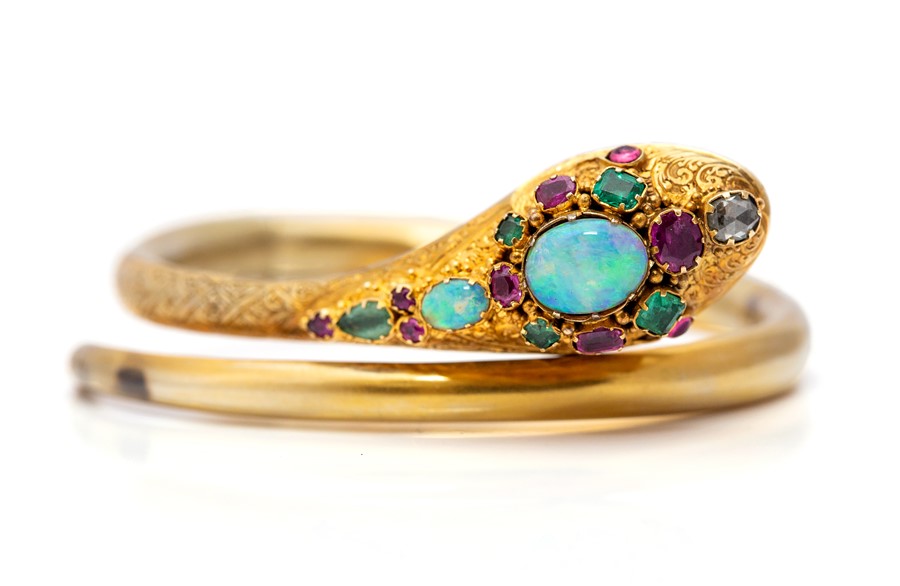 A Victorian opal, ruby, emerald and diamond set serpent bangle, coiled form comprising oval cabochon - Image 9 of 12