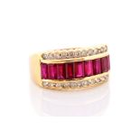 A ruby and diamond 18ct yellow ring, channel set row of step-cut rubies flanked by two rows of round