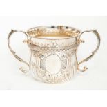 A Victorian silver large two handled porringer, fluted section above vacant cartouche surrounded