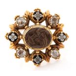 A George IV gold, diamond and onyx mourning brooch, the centre inset with plaited hair, with a