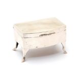 A miniature silver jewellery casket, in the form of a bow-front chest on legs, silk lined