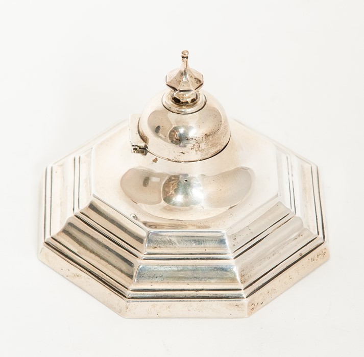 A George I style octagonal plain stepped inkwell, the domed cover with octagonal knop finials, glass