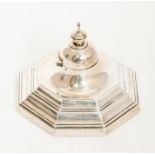 A George I style octagonal plain stepped inkwell, the domed cover with octagonal knop finials, glass