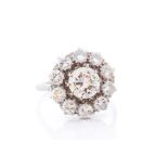 A diamond cluster 18ct white gold and platinum ring, the central round brilliant-cut diamond