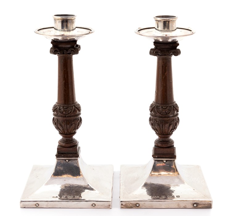 A pair of Arts and Crafts silver and oak candlesticks, A.E.Jones Birmingham 1914, approx 21.5cm