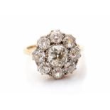 A diamond flower head 18ct gold cluster ring, comprising old cut diamonds, the principal stone