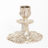 A Victorian desk candlestick, on circular base chase with profuse scrolling foliage and flowers,