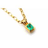 An emerald and 18ct gold pendant, the rub-over set emerald-cut emerald weighing approx 1.30