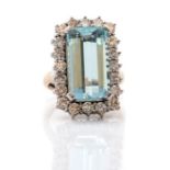 An aquamarine and diamond 18ct white gold cocktail ring, the step-cut rectangular aquamarine approx.